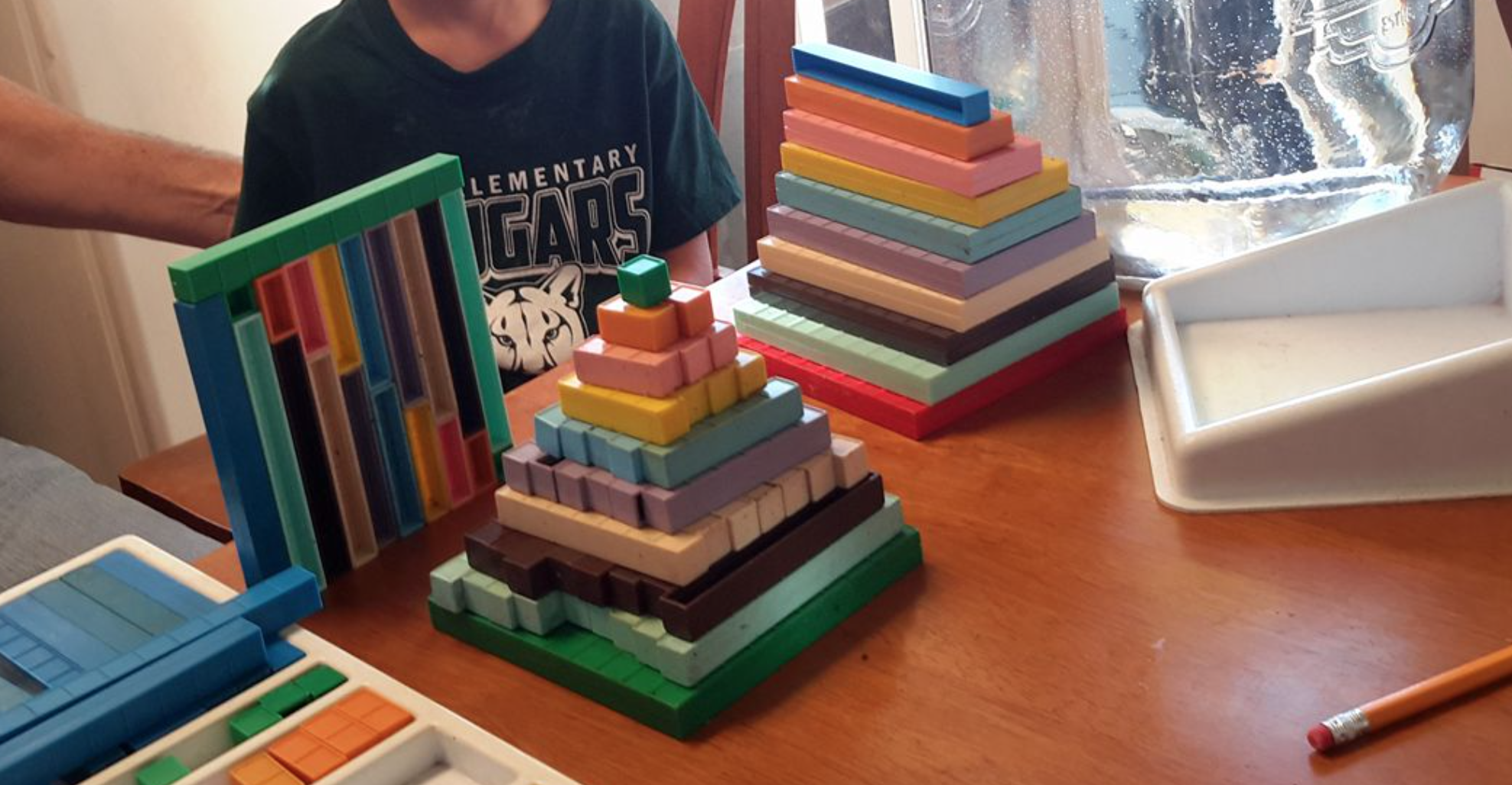 three base ten block pyramids on the kitchen table, mortensen math